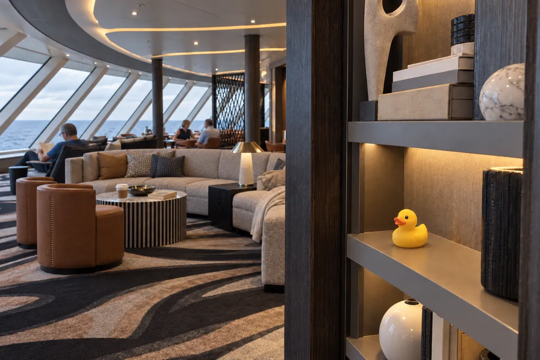 Illustration of a yellow rubber duck on an open shelf in a cruise ship observation lounge.